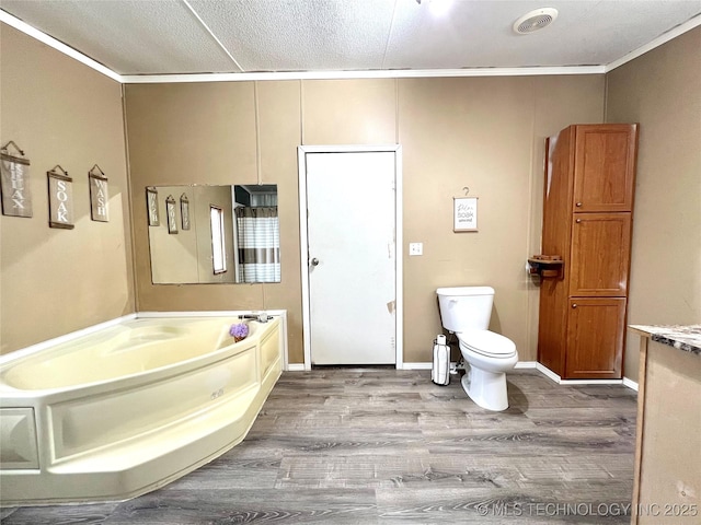 full bathroom with visible vents, toilet, ornamental molding, wood finished floors, and a garden tub