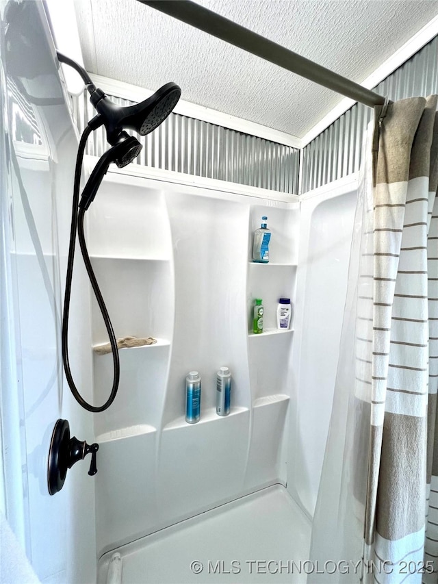 bathroom featuring a textured ceiling and a shower with curtain