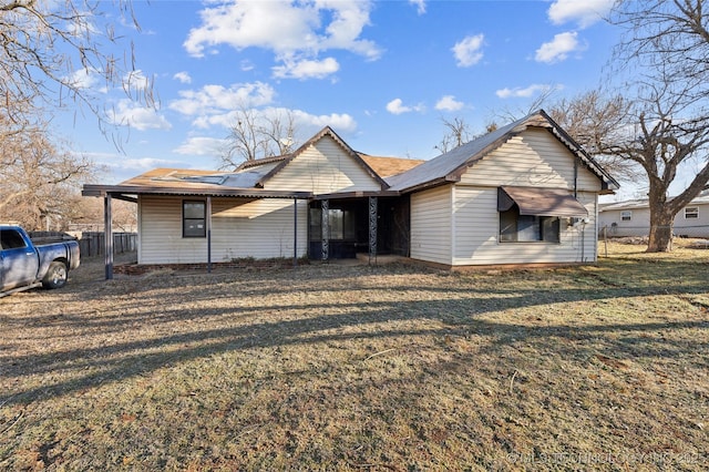 bungalow-style home featuring a front yard and fence