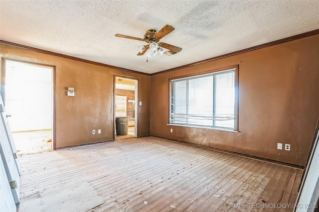 spare room featuring hardwood / wood-style flooring, a textured ceiling, a ceiling fan, and crown molding