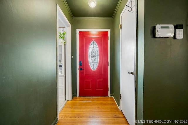 doorway featuring light wood-style floors and crown molding