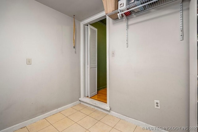 interior space featuring light tile patterned floors and baseboards