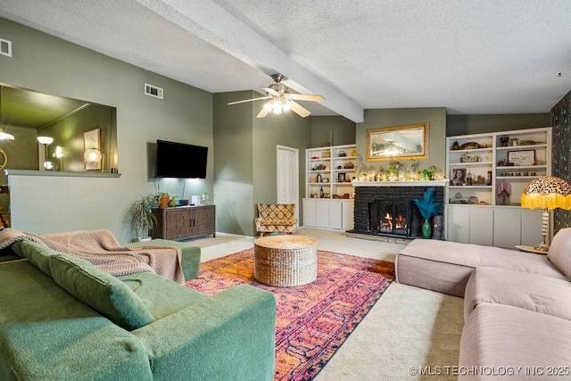 carpeted living room with lofted ceiling with beams, a lit fireplace, visible vents, and a textured ceiling