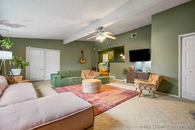 living area with baseboards, carpet, visible vents, and a textured ceiling