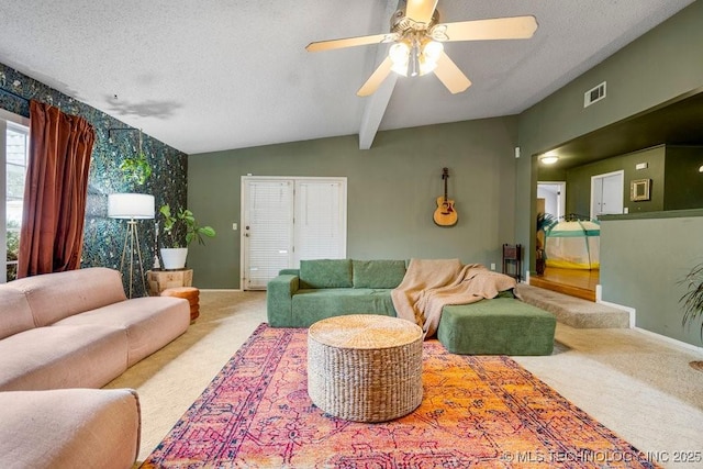 carpeted living room featuring lofted ceiling with beams, a textured ceiling, visible vents, and baseboards