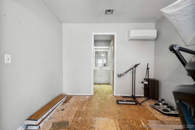 workout area with visible vents and a wall mounted AC