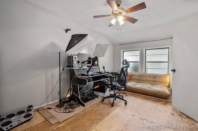 home office with vaulted ceiling and a ceiling fan