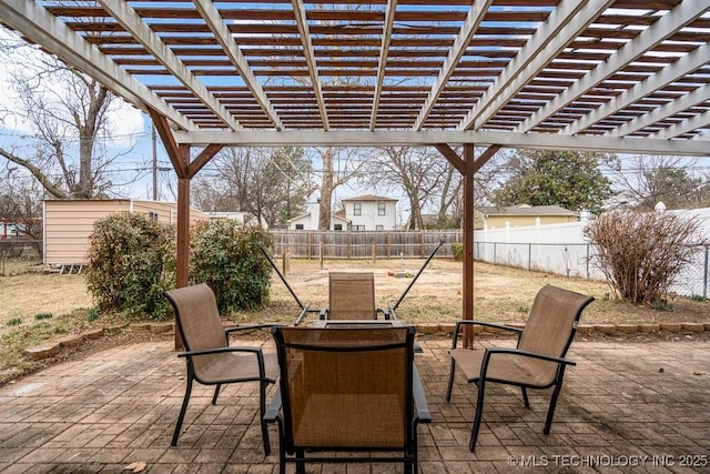 view of patio with an outbuilding and a fenced backyard