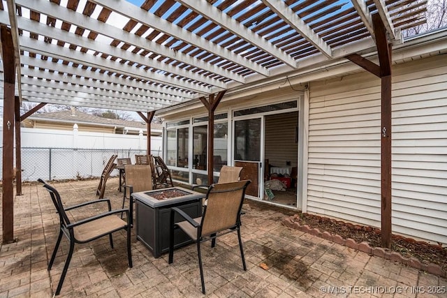 view of patio / terrace with fence, a fire pit, and a pergola