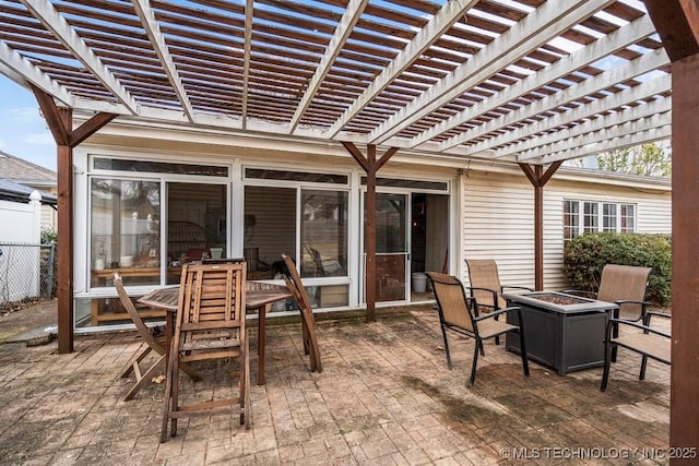 view of patio / terrace featuring an outdoor fire pit, fence, and outdoor dining space