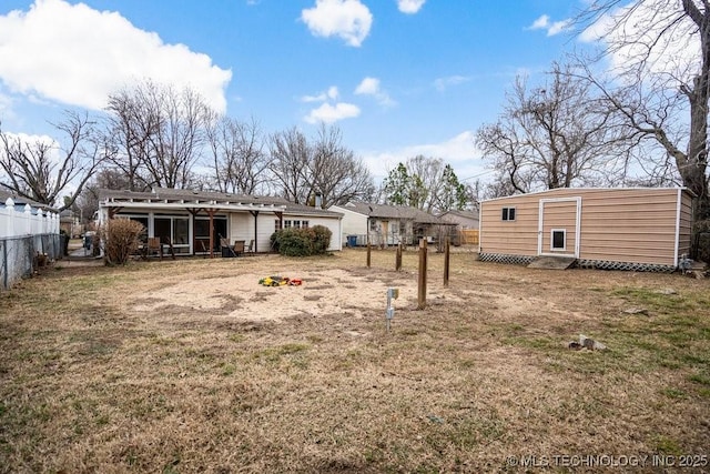 rear view of property with fence and a lawn