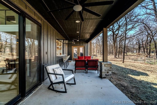 view of patio with a ceiling fan, french doors, and an outdoor living space