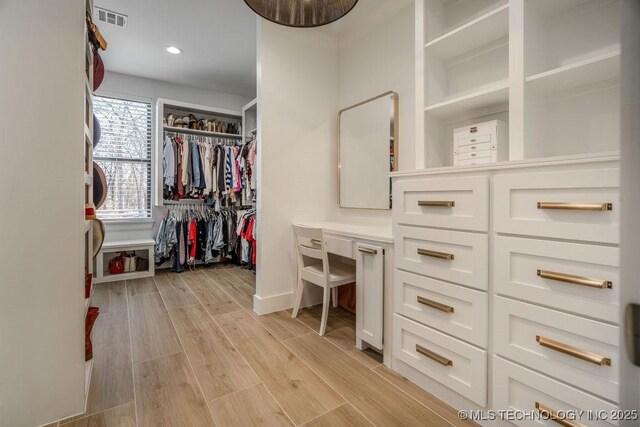 spacious closet featuring light wood-style flooring and visible vents