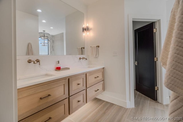 full bath with recessed lighting, a sink, backsplash, and double vanity