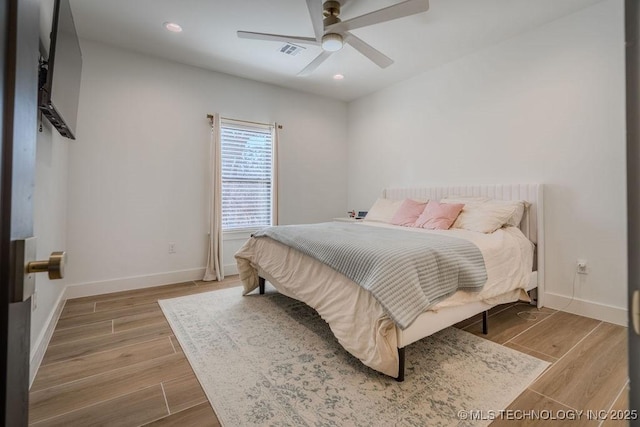 bedroom featuring baseboards, visible vents, and wood finished floors