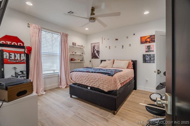 bedroom featuring baseboards, wood finished floors, visible vents, and recessed lighting