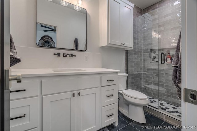 full bath with tile patterned floors, a shower stall, toilet, and vanity