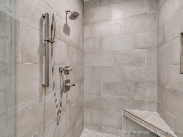 bathroom with a tile shower