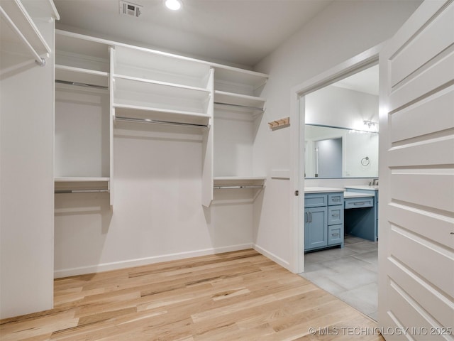 walk in closet with visible vents and light wood-style flooring