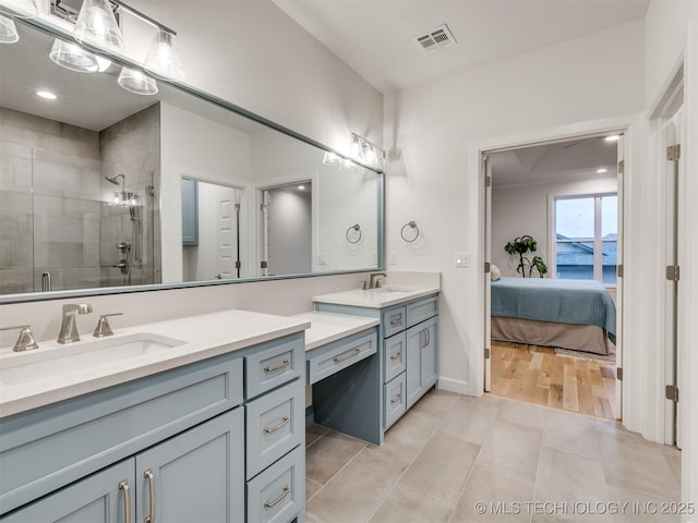 ensuite bathroom featuring visible vents, a stall shower, vanity, ensuite bath, and tile patterned floors