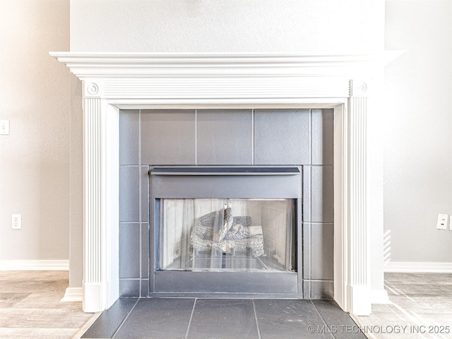 room details featuring a fireplace and baseboards