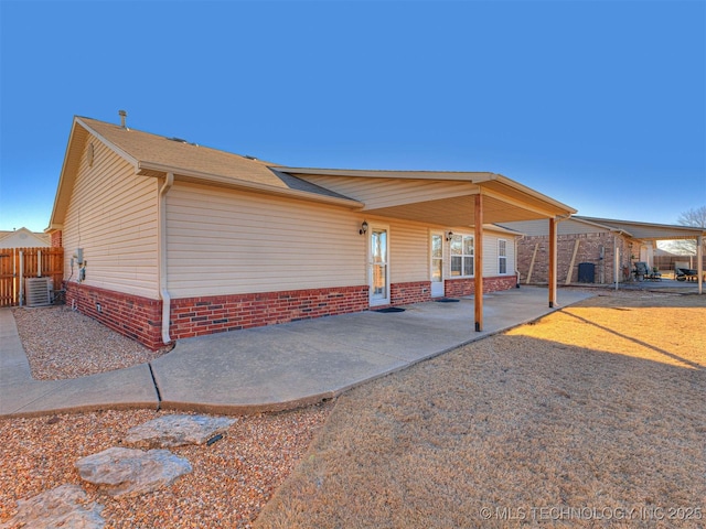 exterior space featuring central AC unit, fence, and a patio