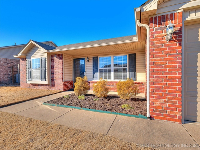 view of front of house with brick siding and an attached garage