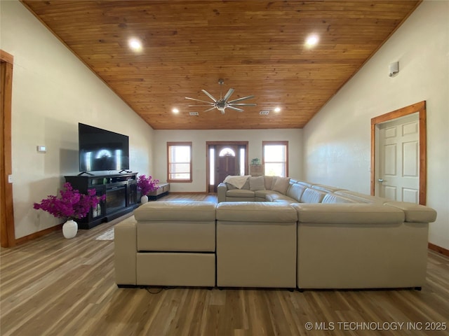 living room featuring baseboards, wooden ceiling, ceiling fan, light wood-style floors, and high vaulted ceiling