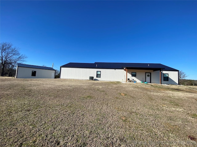 rear view of house with a pole building and an outdoor structure