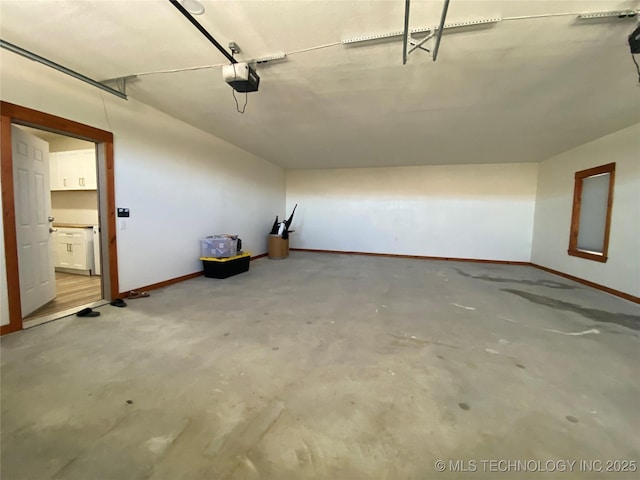 garage with a garage door opener and baseboards