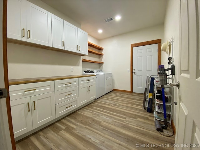 laundry area featuring light wood-style flooring, recessed lighting, visible vents, cabinet space, and washer and clothes dryer