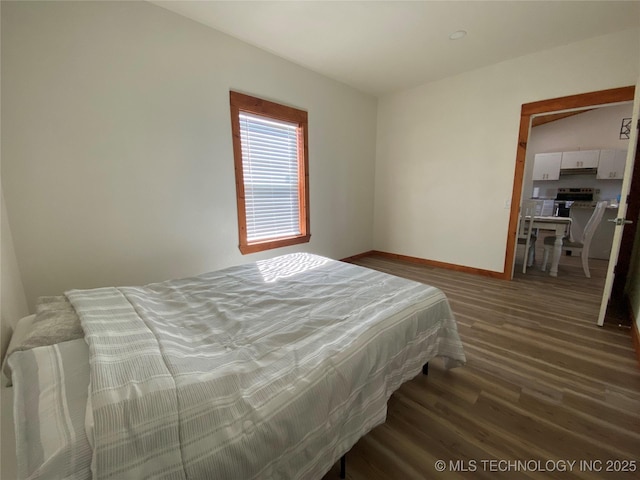 bedroom featuring baseboards and wood finished floors