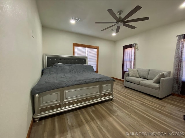 bedroom with recessed lighting, visible vents, ceiling fan, wood finished floors, and baseboards