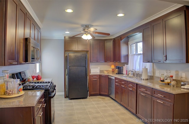 kitchen featuring ceiling fan, light stone counters, a sink, black appliances, and crown molding