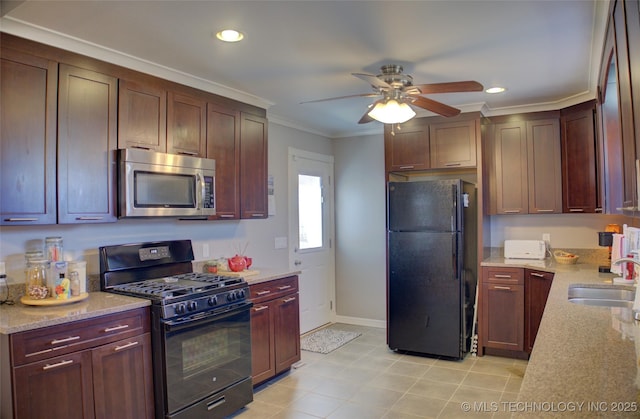 kitchen featuring black appliances, ornamental molding, light stone counters, and a sink