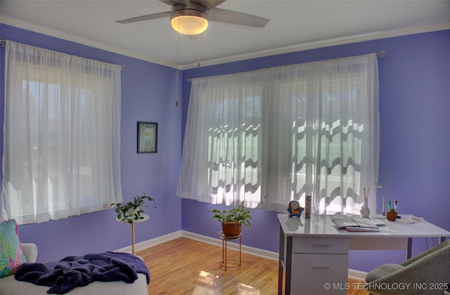 home office with a ceiling fan, light wood-style flooring, and baseboards