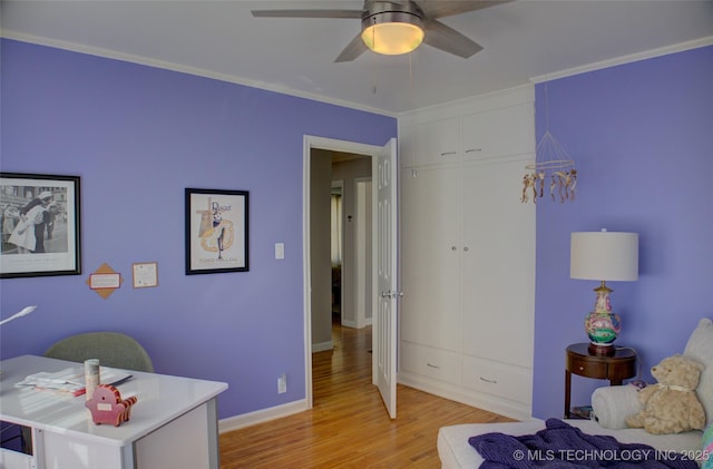 bedroom featuring crown molding, a closet, a ceiling fan, light wood-type flooring, and baseboards