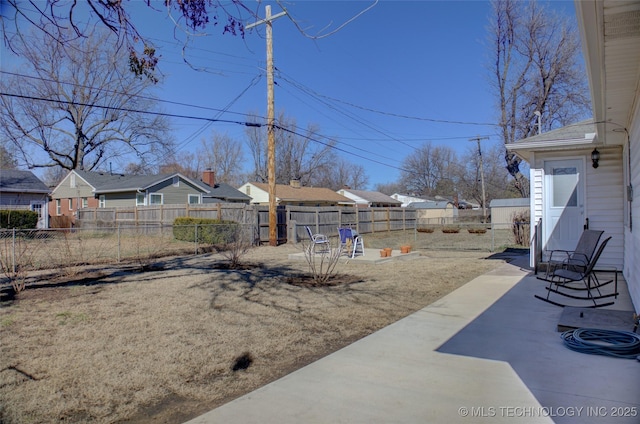 view of yard featuring fence private yard, a patio area, and a residential view