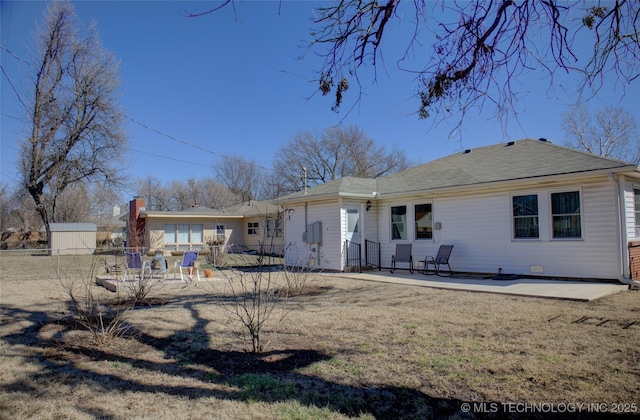 rear view of house featuring a patio area and fence