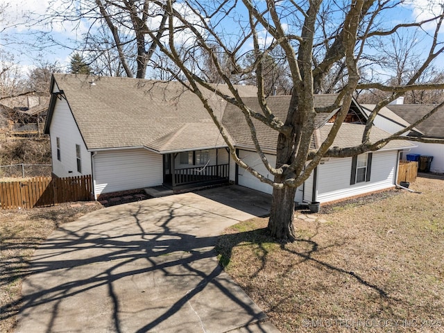 single story home with a garage, roof with shingles, fence, and driveway