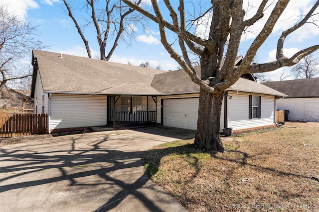 ranch-style home featuring a shingled roof, concrete driveway, covered porch, fence, and a garage