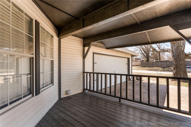 wooden terrace with a garage