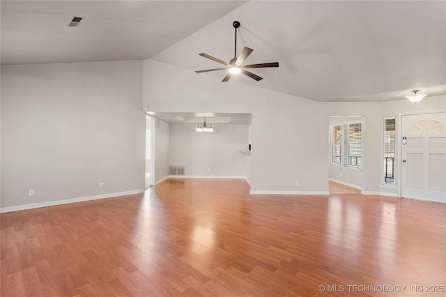 unfurnished living room featuring ceiling fan with notable chandelier, visible vents, and light wood-style floors