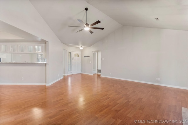 unfurnished living room featuring high vaulted ceiling, light wood-style flooring, baseboards, and a ceiling fan