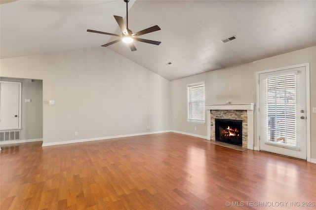 unfurnished living room featuring light wood finished floors, visible vents, and a wealth of natural light