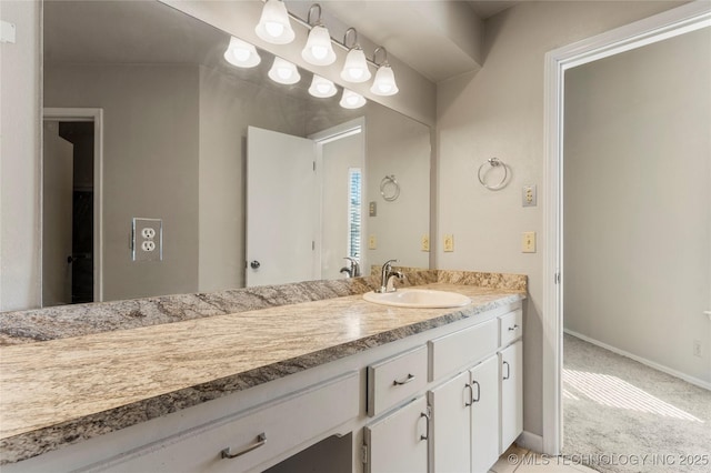 bathroom with vanity and baseboards