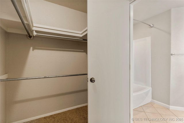 spacious closet with tile patterned floors