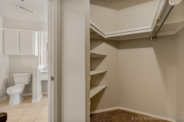 spacious closet featuring light tile patterned floors and visible vents