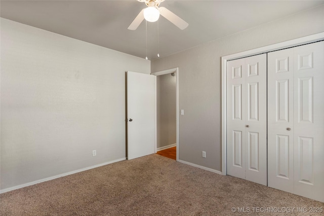 unfurnished bedroom with carpet, ceiling fan, and a closet