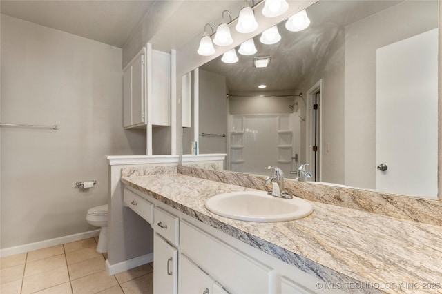 bathroom with a shower, toilet, vanity, baseboards, and tile patterned floors